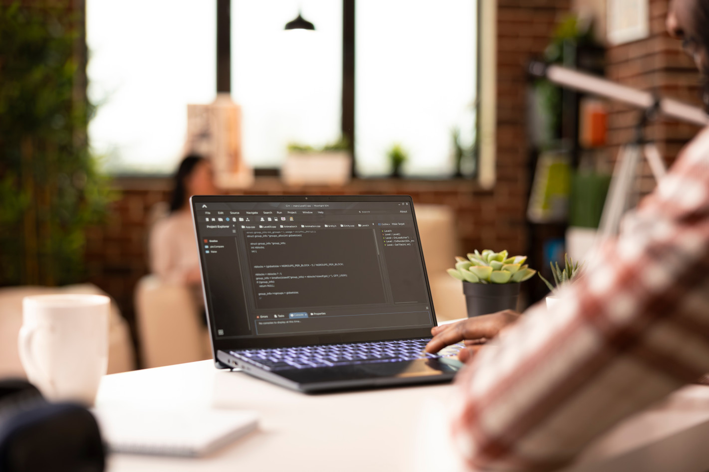 Close-up of student coding HTML and CSS on laptop during IT Specialist training session