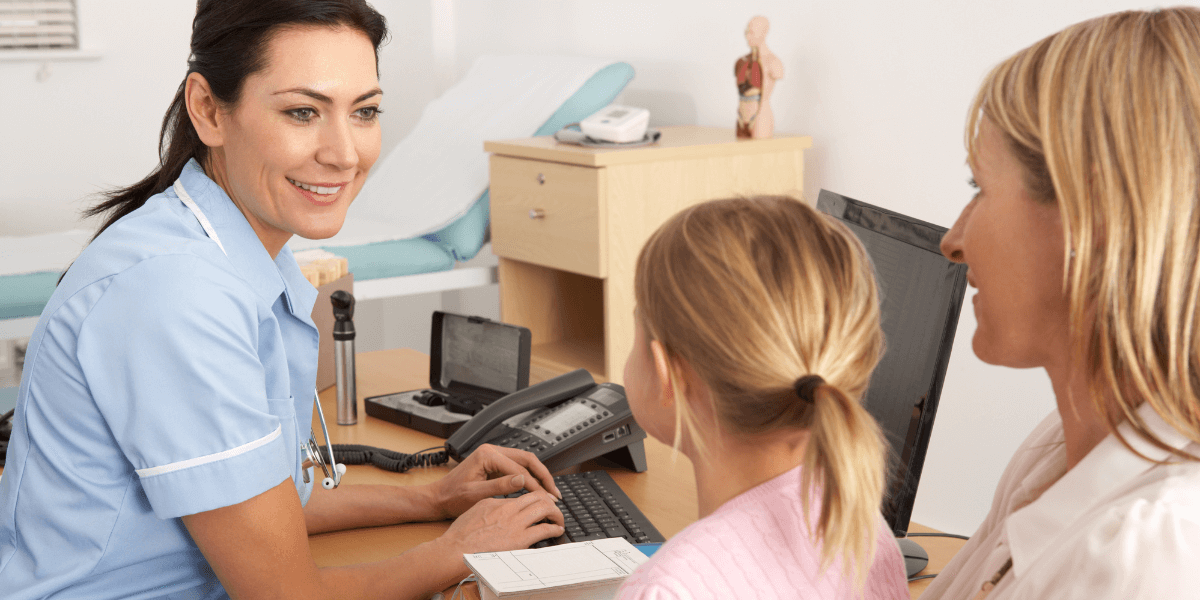 Healthcare worker completing patient medical report at bedside