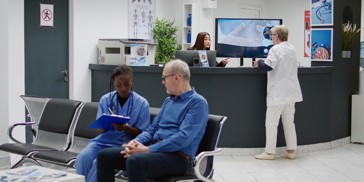 Healthcare professionals working in a medical office reception area, representing service industry workers who benefit from UK minimum wage protections that ensure fair compensation across various employment sectors.