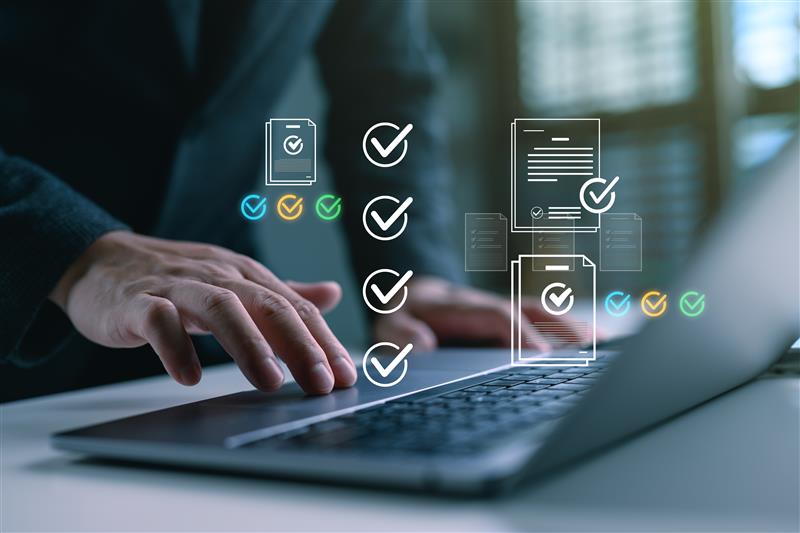 Employer reviewing project documents on a laptop during PRINCE2 project management training for the Oxfordshire Skills Bootcamp.