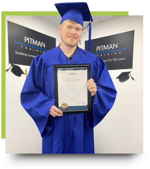 Pitman Training Sheffield graduate James holding his Data Analyst Diploma at graduation