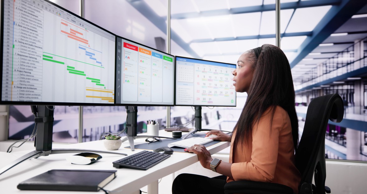Project manager reviewing Gantt charts and workflow dashboards
