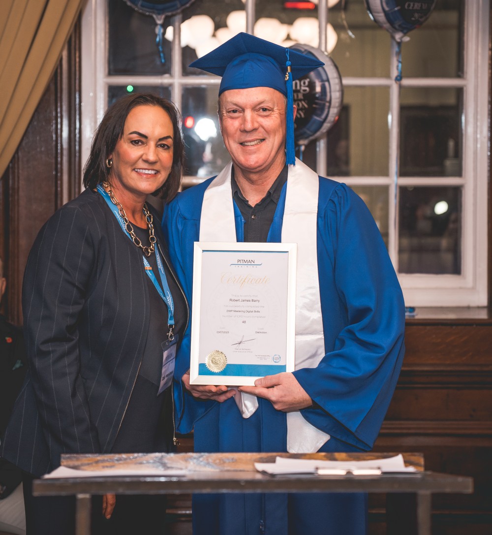 Robert Barry receiving his Student of the Year certificate from Clair Henshaw at the Pitman Training Manchester Graduation Ceremony 2025